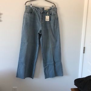 Faded, rough hem, button front jeans